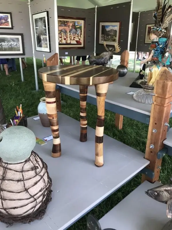 Handcrafted wooden furniture and artwork on display at Art on the Green.