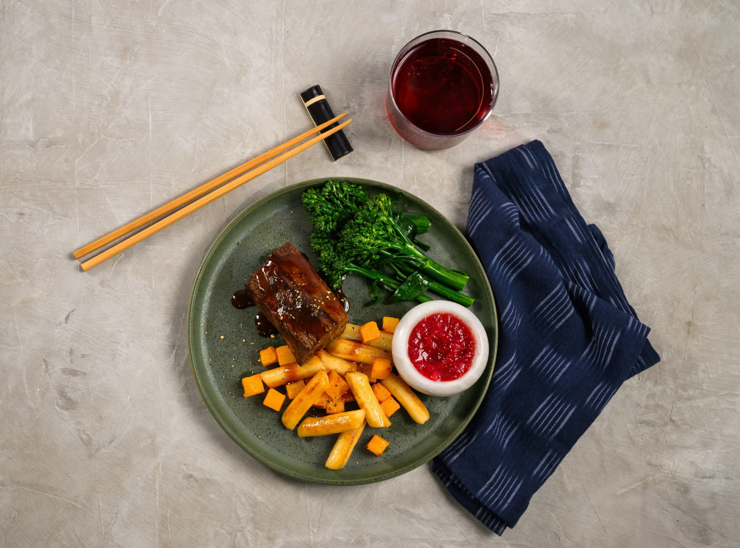 A Chef's Table first class meal on Alaska Airlines featuring glazed short rib and seasonal vegetables
