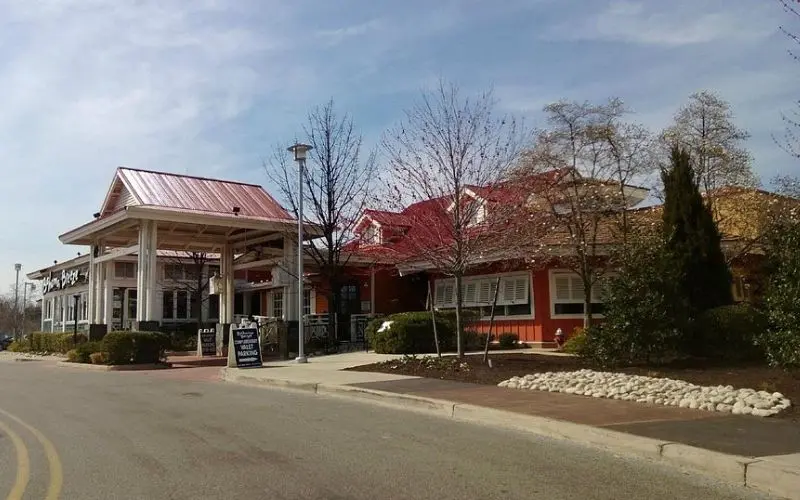Exterior view of Cherry Hill Mall with red-roofed buildings.