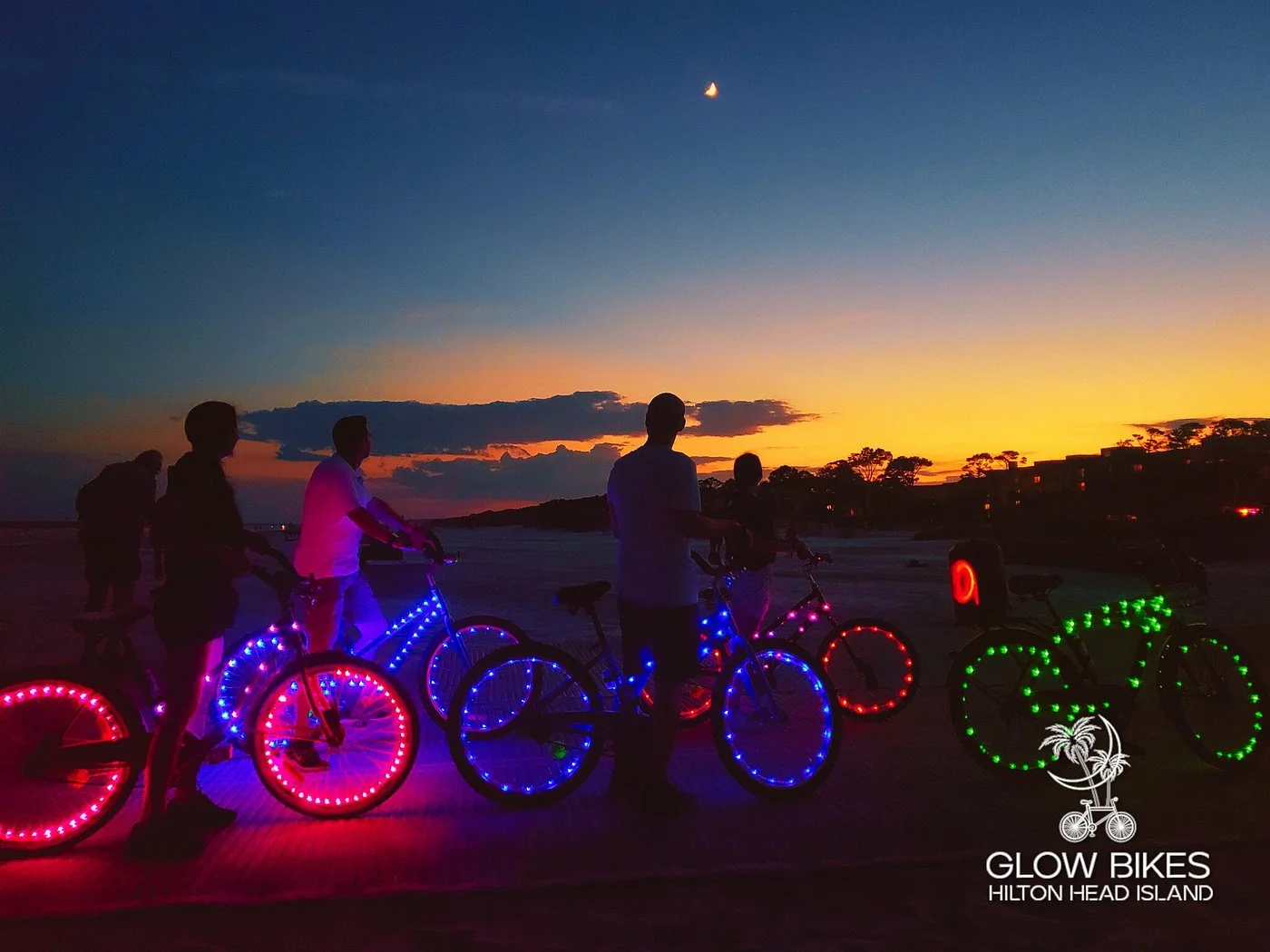 Glow Bikes nighttime tour with LED-lit bicycles against sunset sky, one of the best things to do in Hilton Head Island at night.