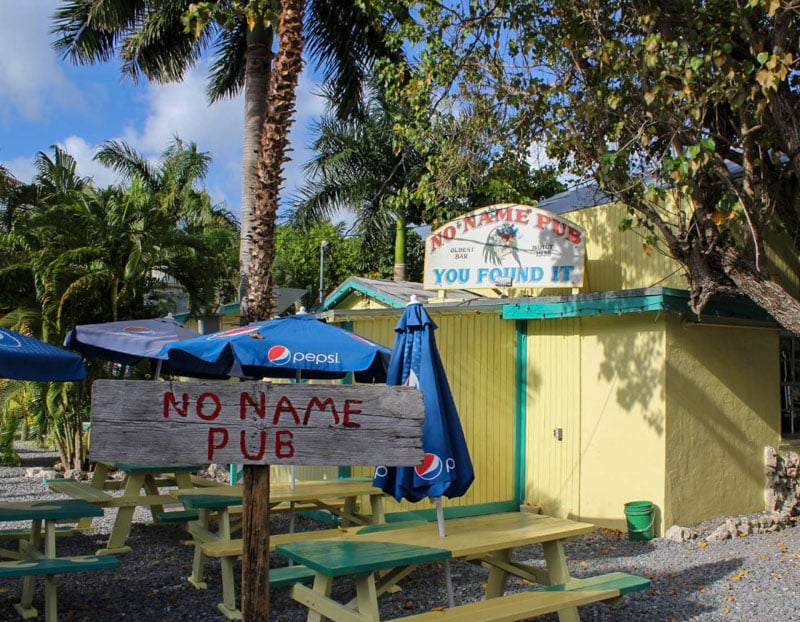 Experience the quirky charm of No Name Pub, where walls and ceilings are adorned with about $90,000 in decorated dollar bills.