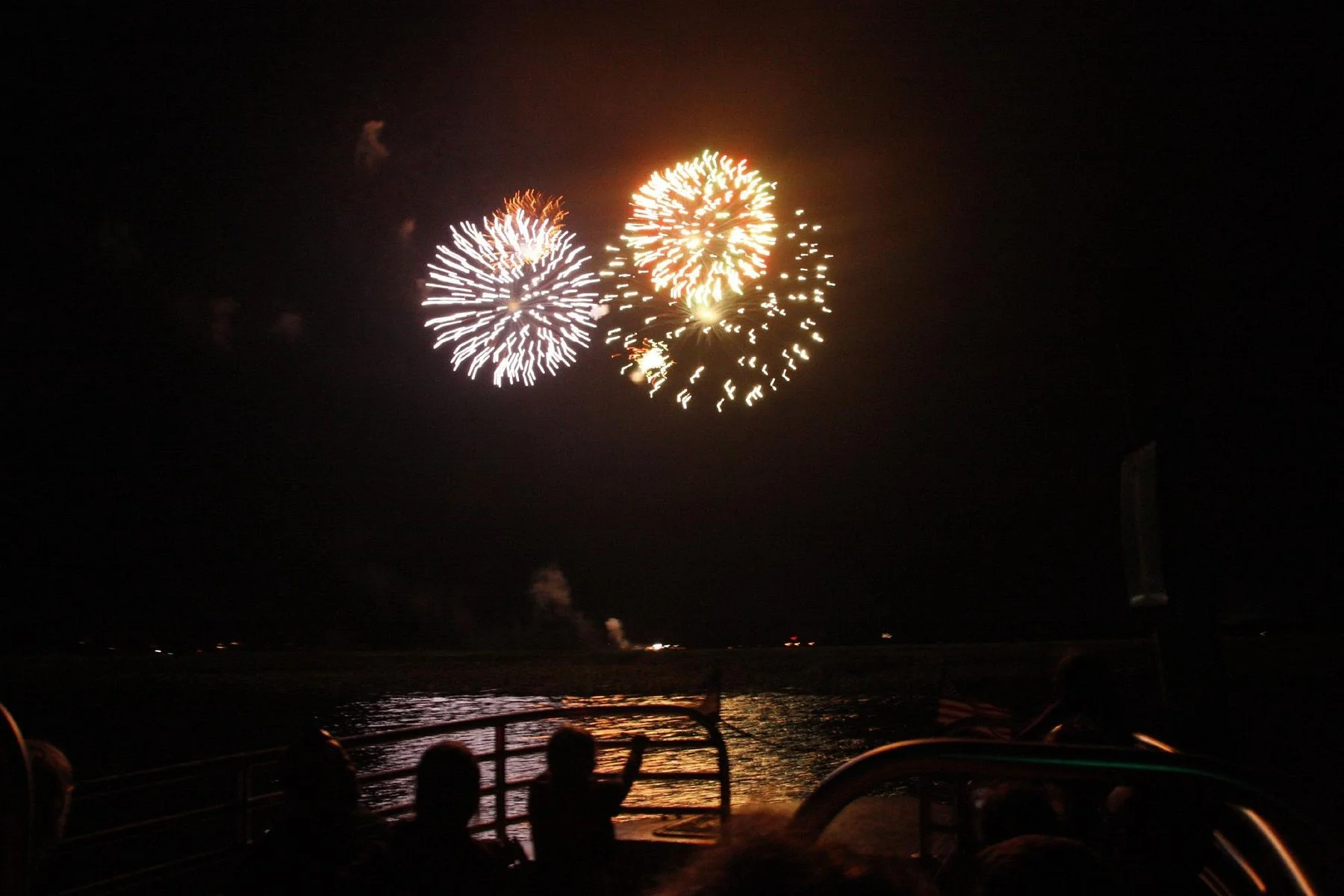 Hilton Head fireworks over water at night from kayak tour.