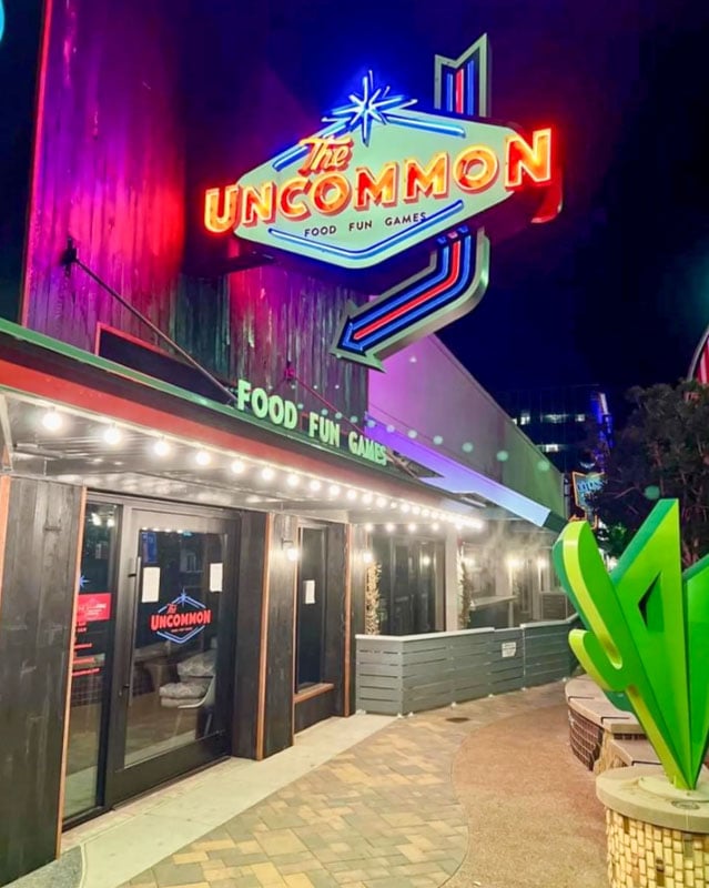 The Uncommon is a nostalgic blast with '70s to '90s vibes, neon lights, arcade games, and serious food and drinks.
