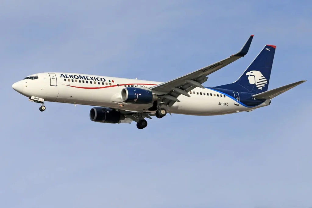 Aeromexico Boeing 737-700 airplane registration EI-DRC flying on landing approach with gear down