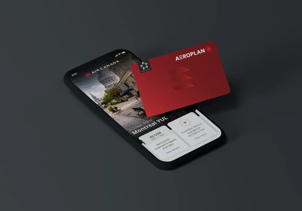 A smartphone displaying a flight itinerary next to a red Aeroplan loyalty card