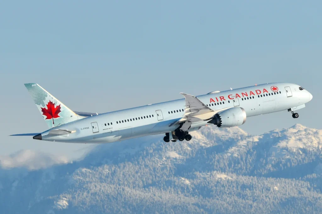 An Air Canada Boeing 777 passenger airplane climbing into the sky