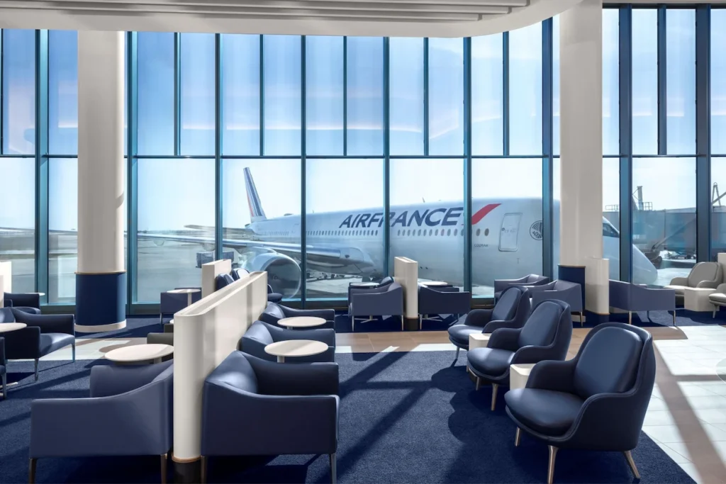 Air France airport lounge seating area looking out at a parked Air France airplane