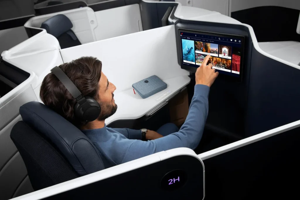 Air France business class seat with a large entertainment screen