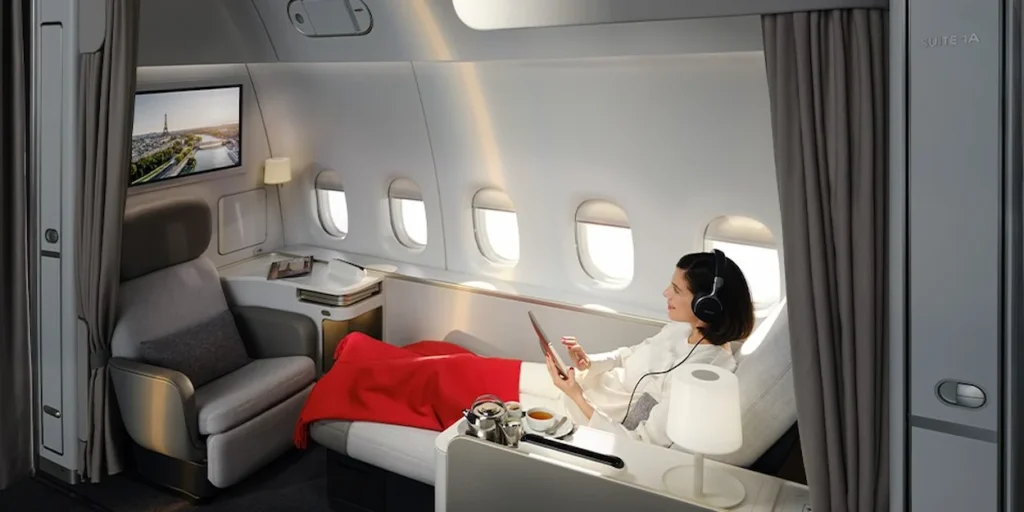 Passenger in an Air France La Première first-class suite with private curtains