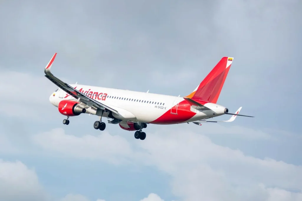 An Avianca Airbus A320neo airplane cruising high in the air against a clear sky