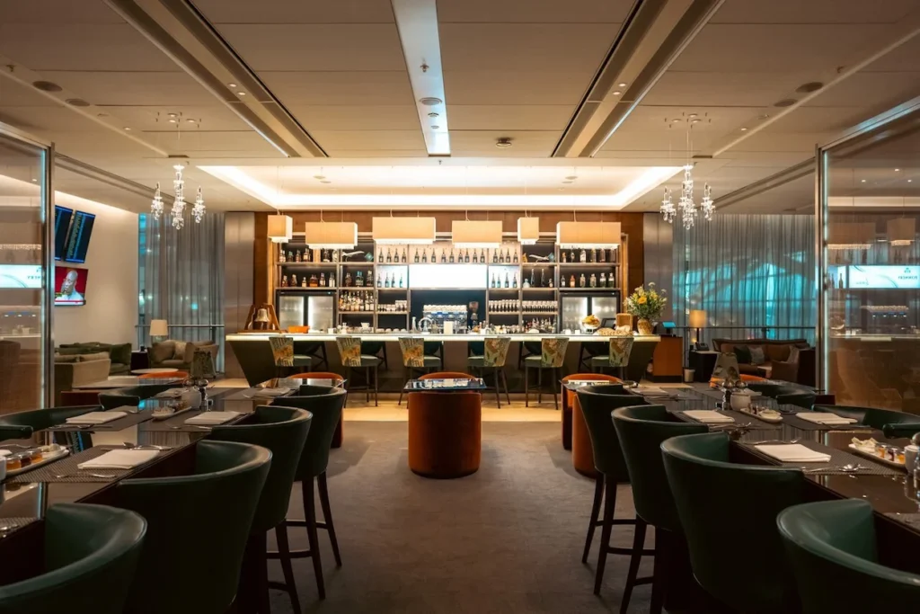 Elegant dining area and illuminated sit-down bar inside British Airways Concorde Room