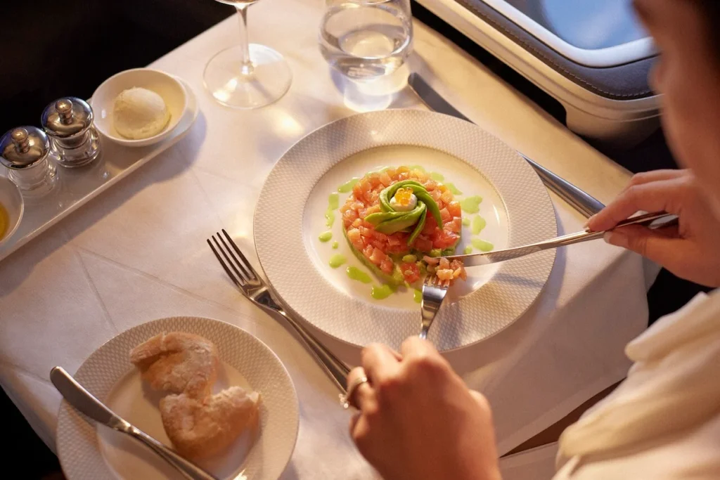Passenger eating a gourmet seafood appetizer on a British Airways flight