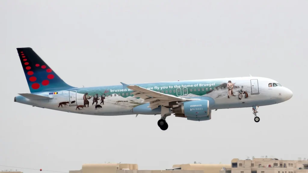 A Brussels Airlines Airbus A320 landing with a special livery featuring classic Bruegel paintings on the fuselage