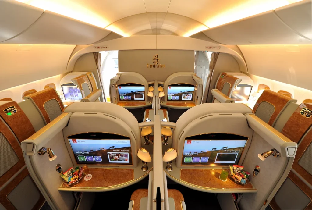 An overhead view of luxury private suites inside an Emirates First Class airplane cabin