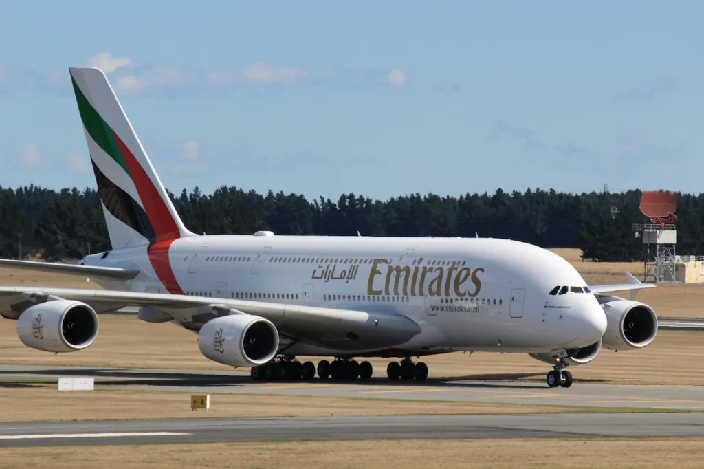 An Emirates Airbus A380 double-decker passenger airplane taxiing on the airport runway tarmac