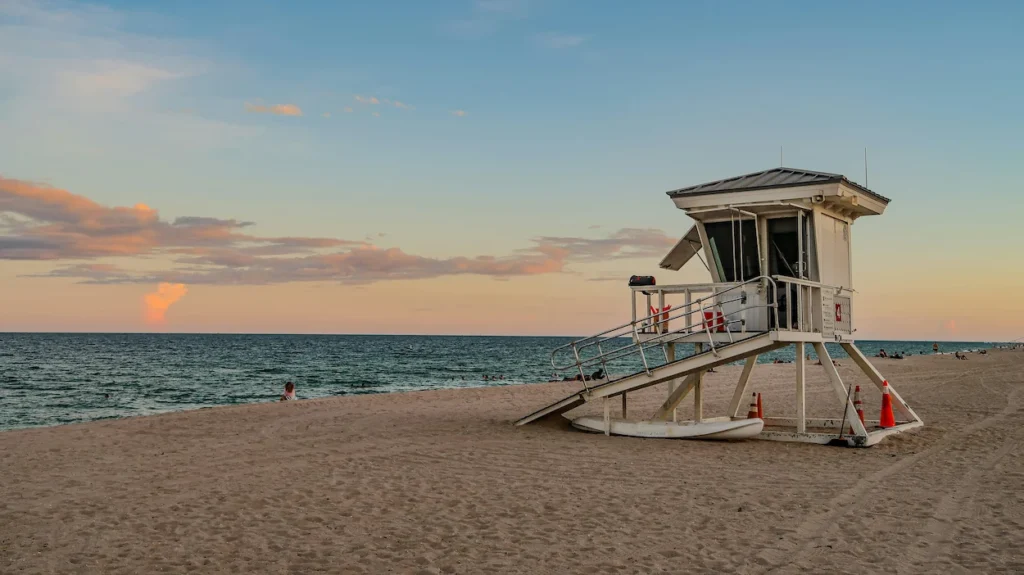 Lifeguard tower on a sandy beach during sunset