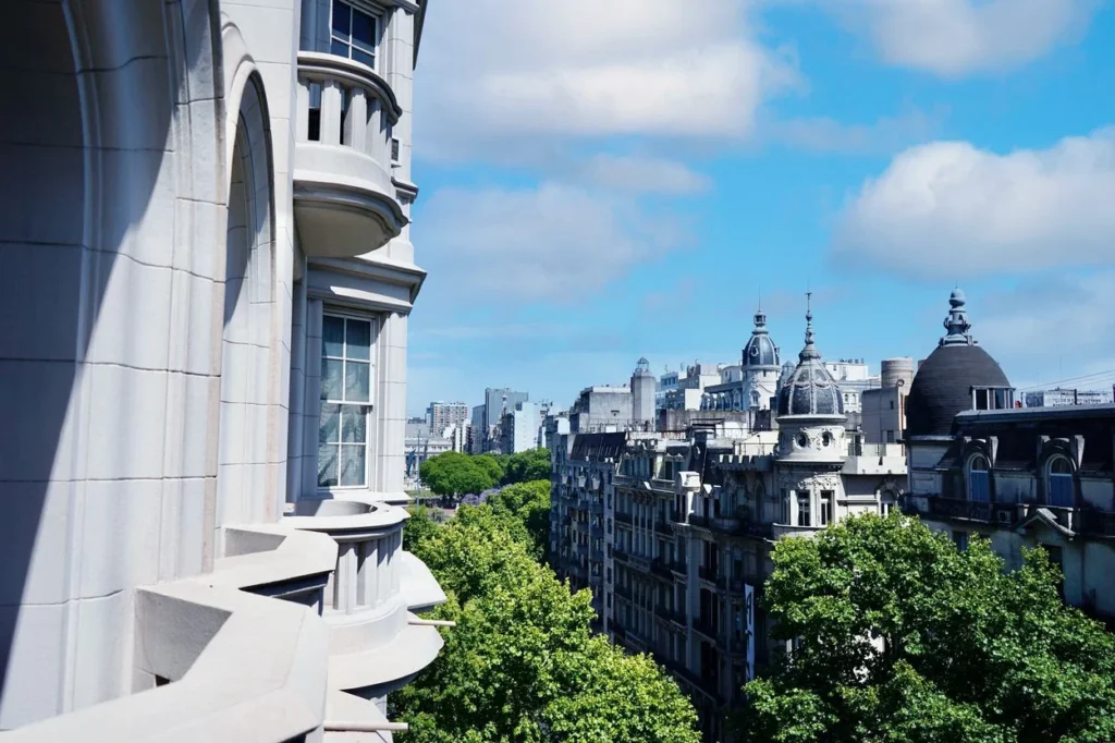 View of European-style buildings and green trees in Buenos Aires from a balcony