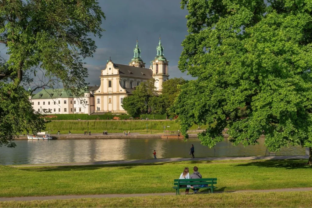 Park bench overlooking the Vistula River and Skałka Church in Kraków