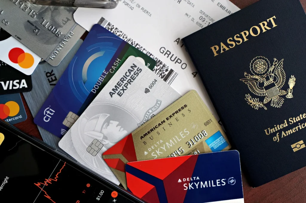 United States passport next to a pile of premium travel rewards and airline credit cards