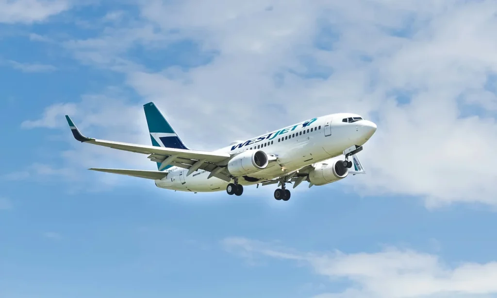 A WestJet Boeing 737 passenger airplane landing with its landing gear deployed