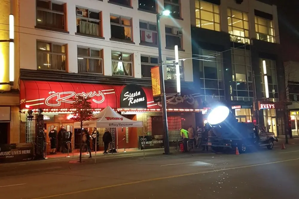 The neon-lit entrance of The Roxy nightclub in Vancouver at night.