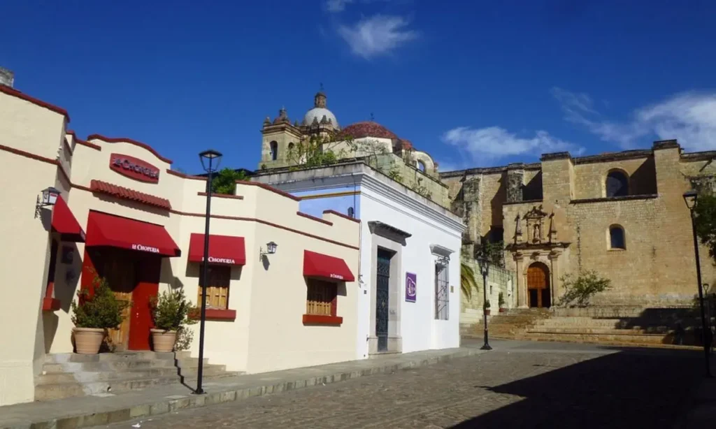 A street in Mexico City with historic buildings and red awnings.