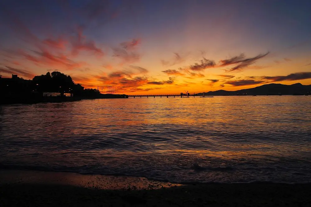A colorful sunset over the ocean at Kitsilano Beach.