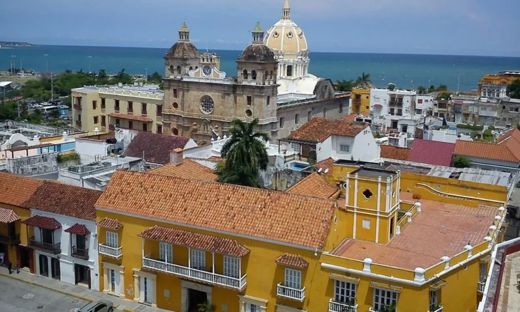 Colorful colonial buildings and a historic church in Cartagena near the coast.