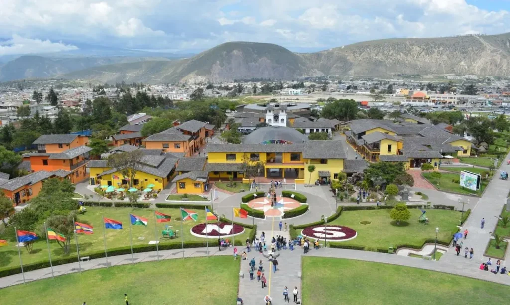 A view of colorful buildings and gardens at the equator line in Quito, Ecuador.