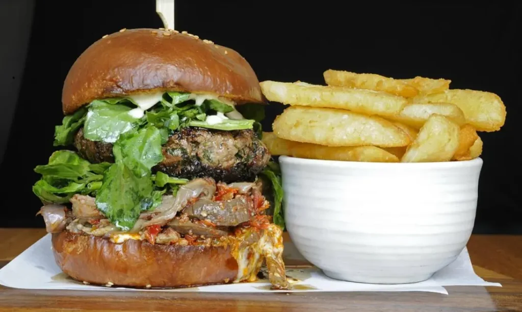 Wagyu beef burger with pickled eggplant, harissa and watercress