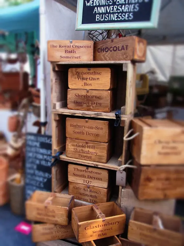 Wooden crates with engraved names on display at Frome Independent Market.