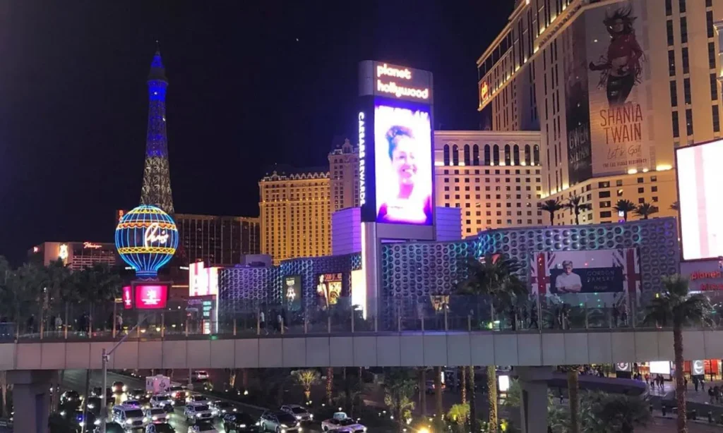 Bright lights and busy streets of the Las Vegas Strip at night.