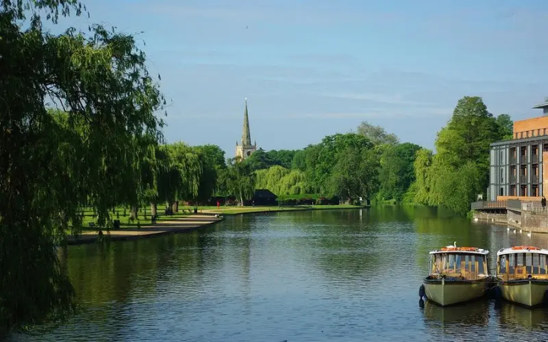 River Avon with boats and church spire in the background.