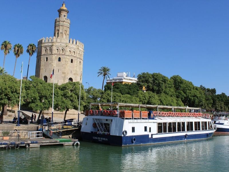 As night falls, embark on a captivating journey along the Guadalquivir River, immersing yourself in its enchanting atmosphere.
