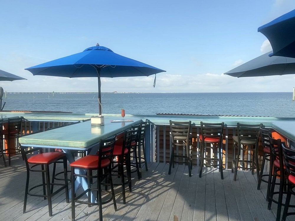 Outdoor seating with ocean views at Lobo Del Mar Cafe.