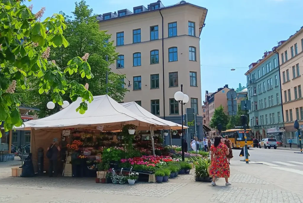An outdoor market tent filled with colorful flowers