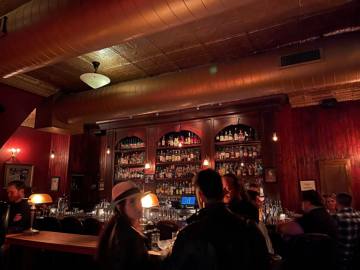 Step into Williams & Graham's warm, wood-paneled interior where craft cocktails meet prohibition-era charm.