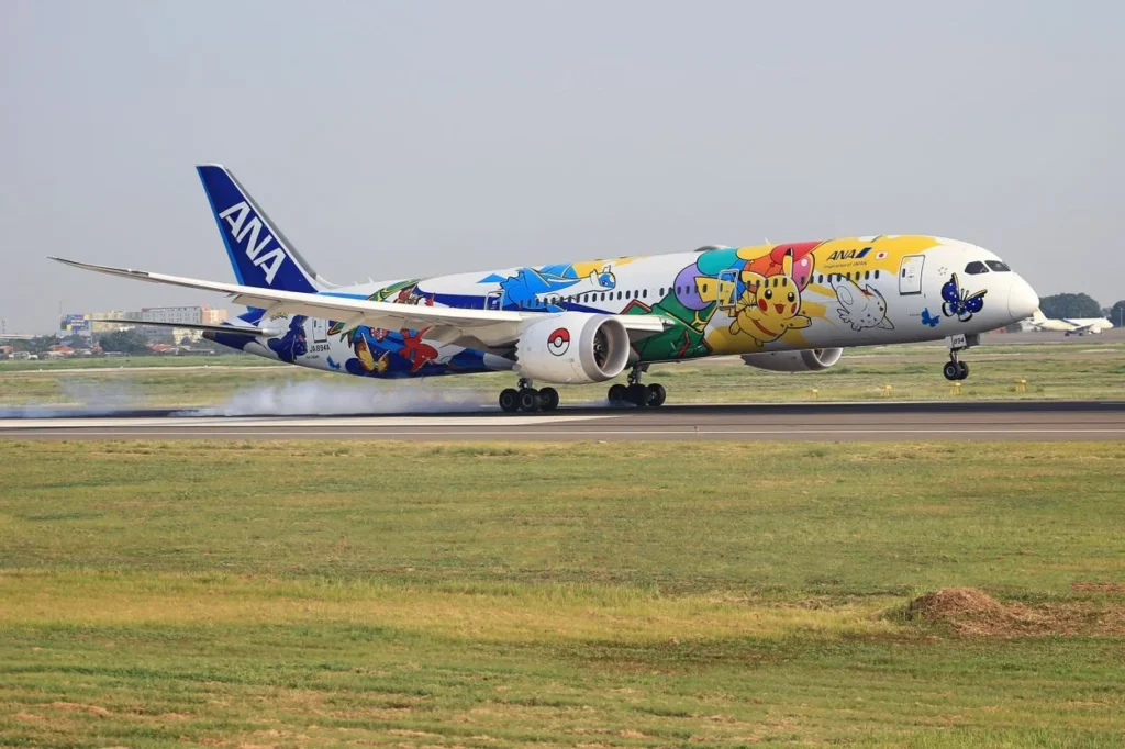 An All Nippon Airways (ANA) Boeing 787-9 Dreamliner passenger airplane in a colorful Pokémon Pikachu Jet livery