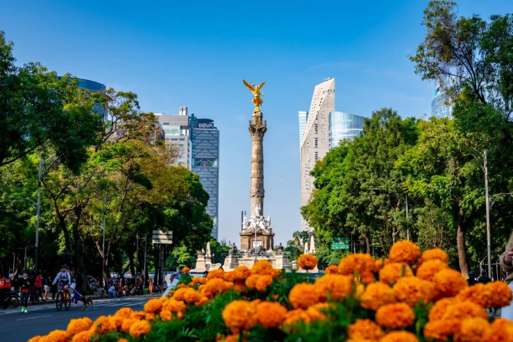 Angel of Independence monument framed by orange marigolds in Mexico City