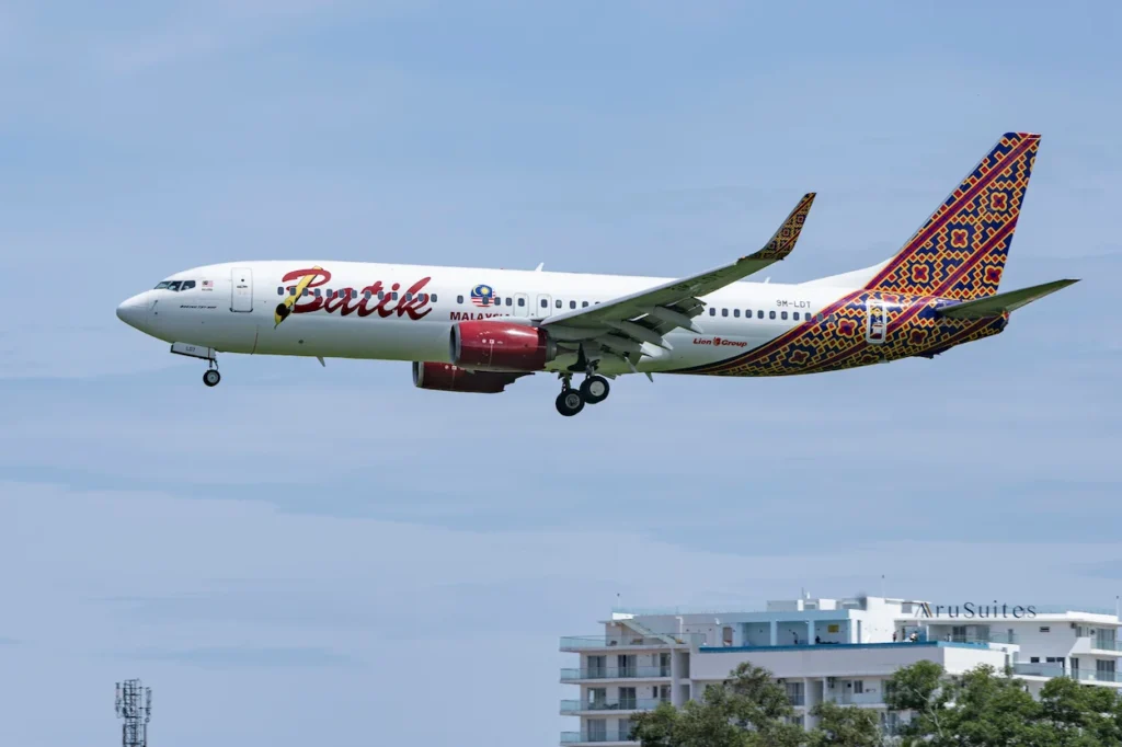 Batik Air Malaysia Boeing 737 airplane landing over building