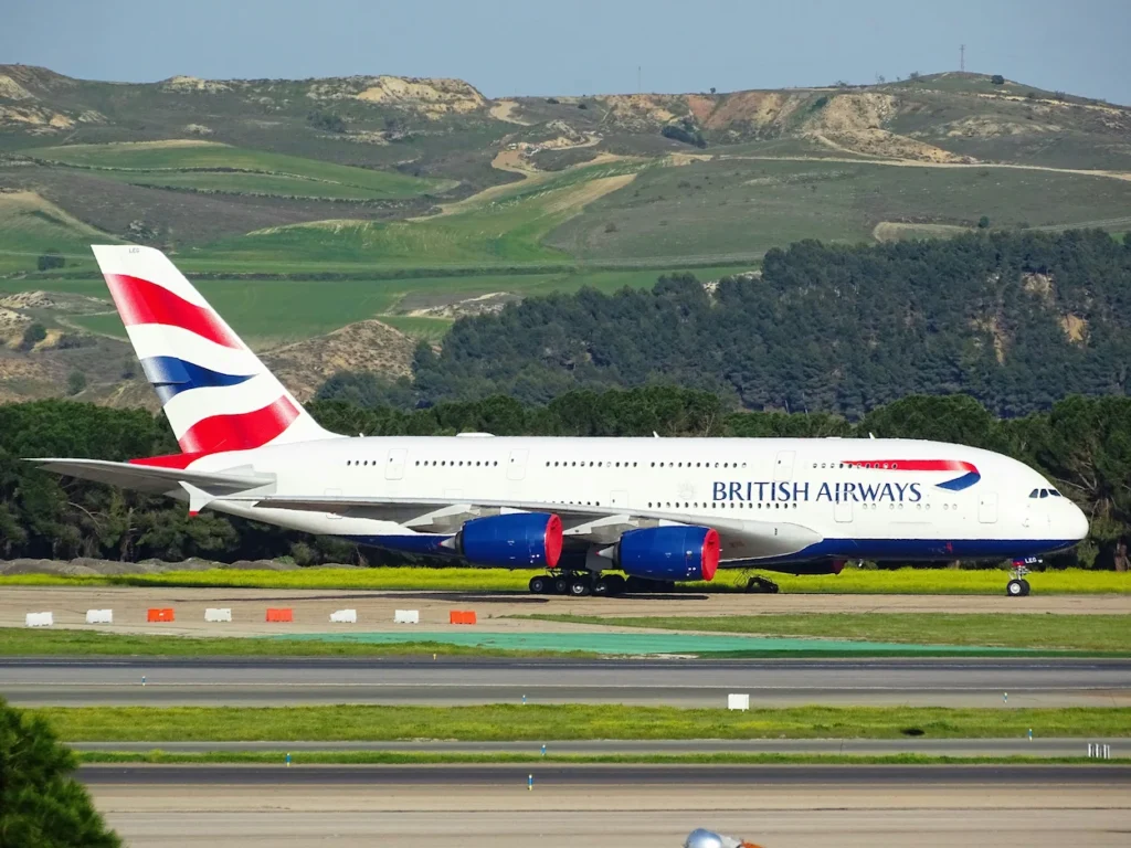 A British Airways Airbus A380 taxiing along a concrete airport taxiway