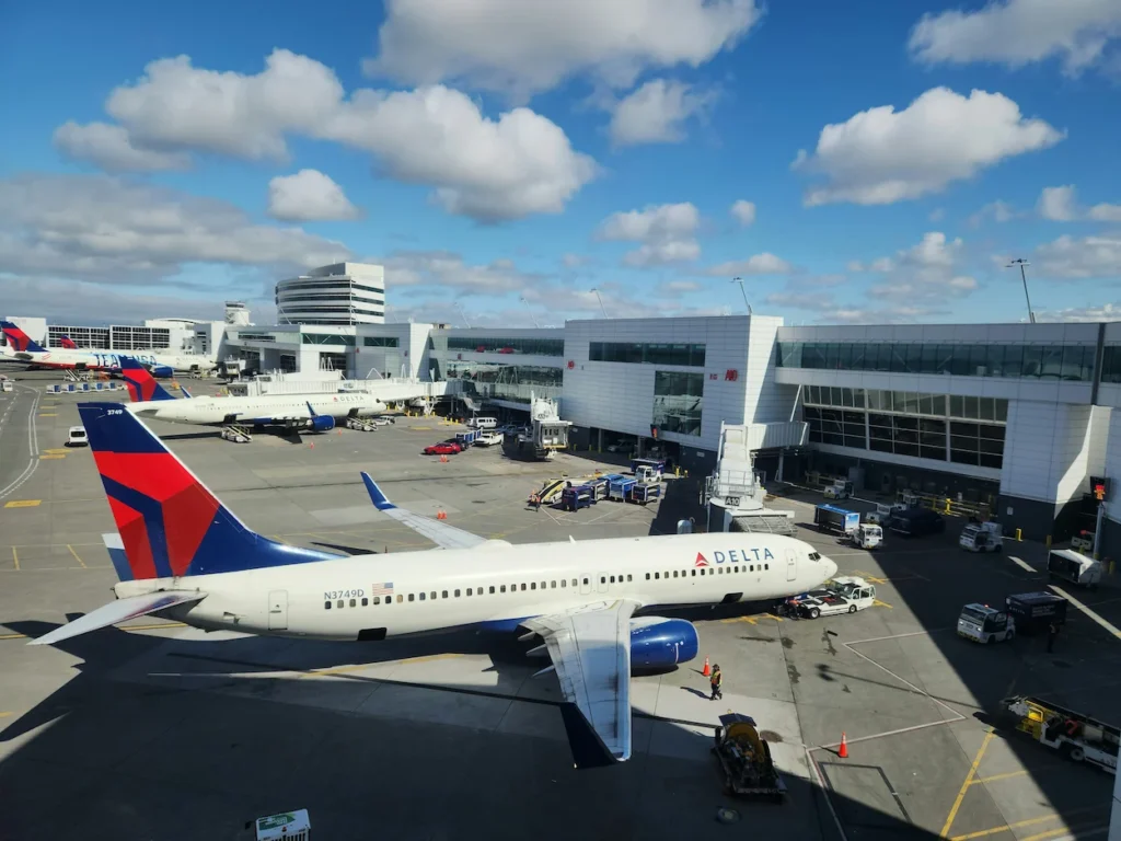 A Delta Air Lines Boeing 737 parked at a terminal gate at Seattle-Tacoma International Airport
