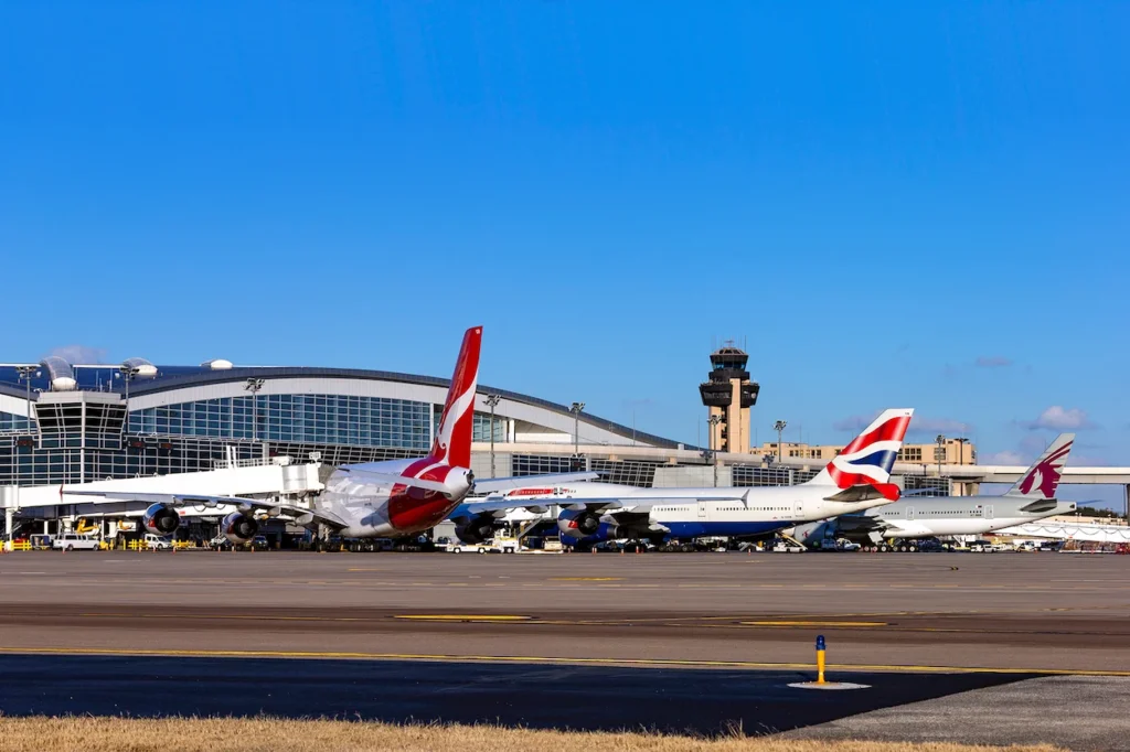 Qantas, British Airways, and Qatar planes parked at DFW Airport Terminal D