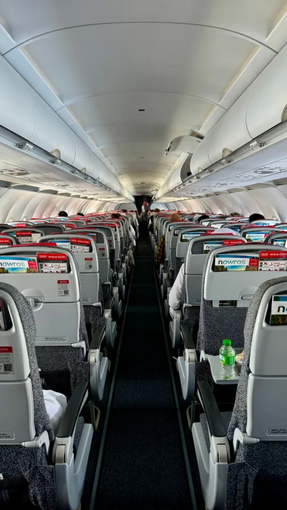 View down the center aisle of a commercial airplane economy cabin