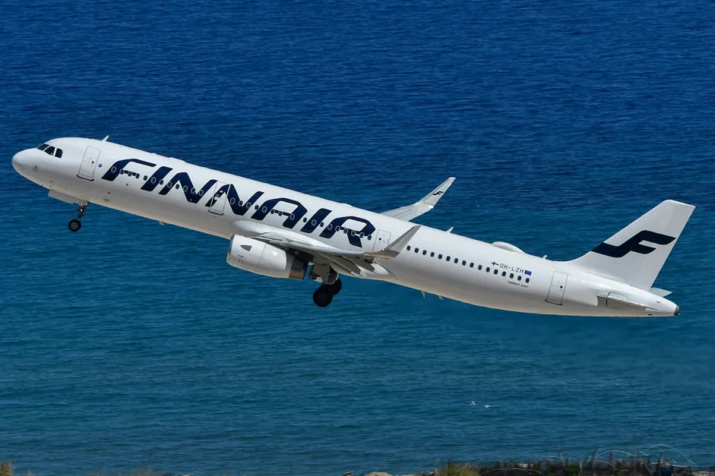 Finnair Airbus A321 passenger airplane climbing into the air after taking off