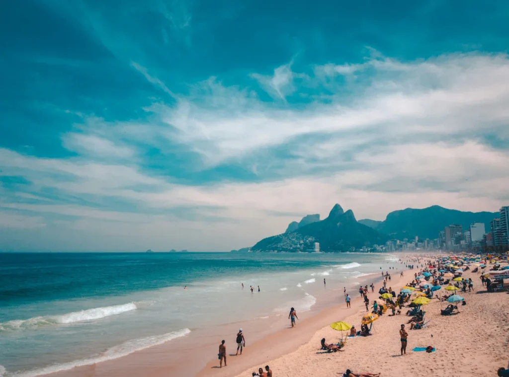 Crowded Ipanema Beach with the Dois Irmãos mountains in Rio de Janeiro, Brazil