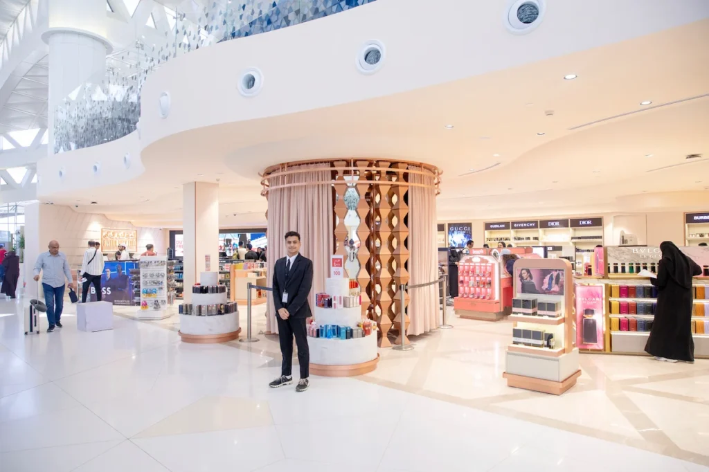 A bright luxury cosmetics and perfume duty-free shopping area inside King Khalid International Airport
