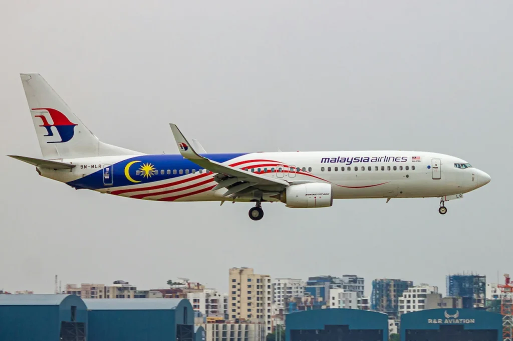 A Malaysia Airlines Boeing 737-800 passenger airplane in the special Negaraku livery descending on final approach