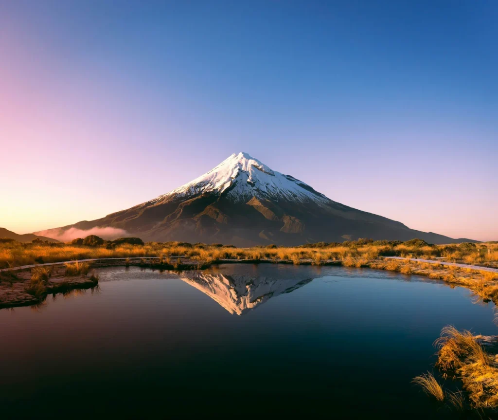 Mount Taranaki reflecting in the Pouakai Tarn at sunset in New Zealand