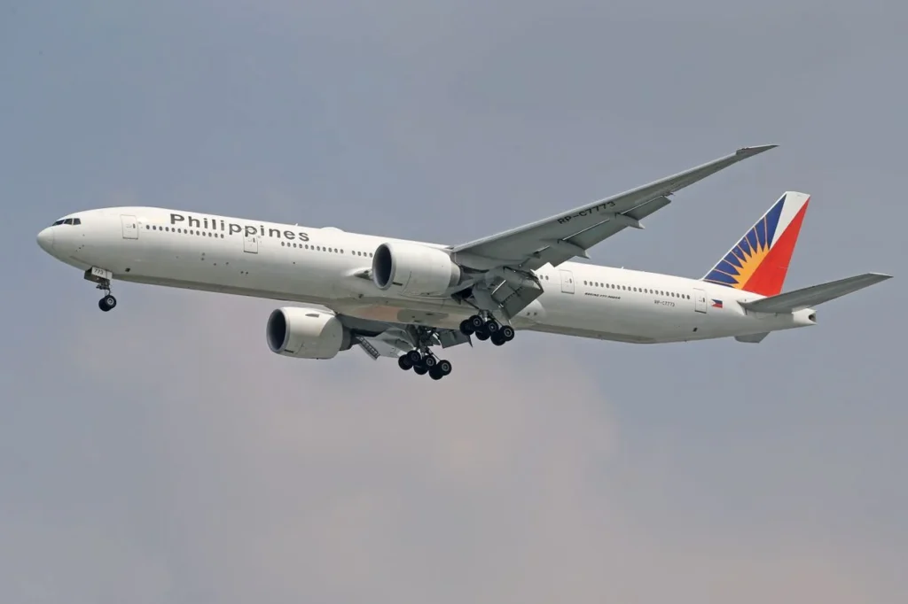 A Philippine Airlines Boeing 777-300ER passenger airplane descending to land